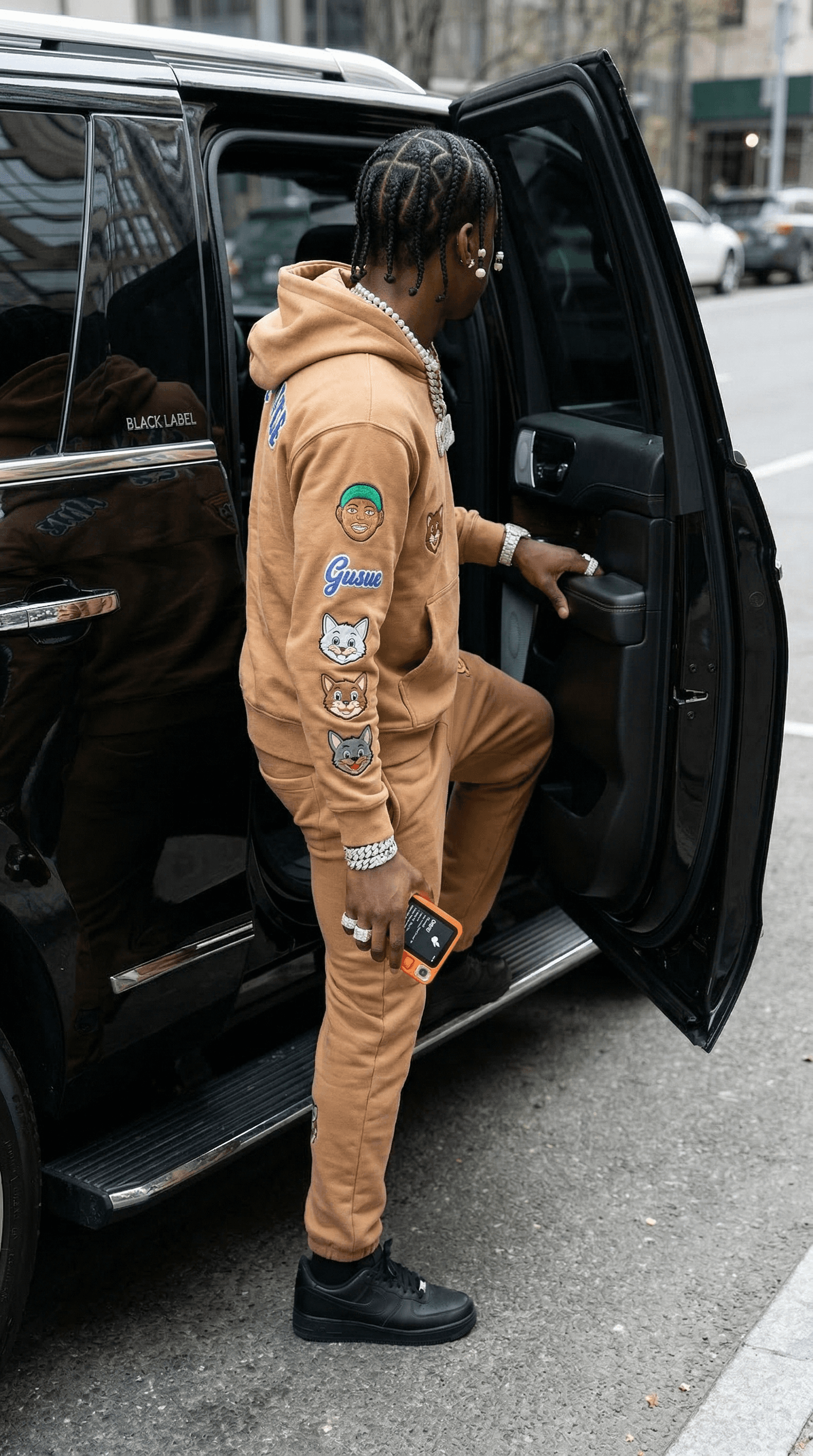 Subject getting into luxury SUV with device