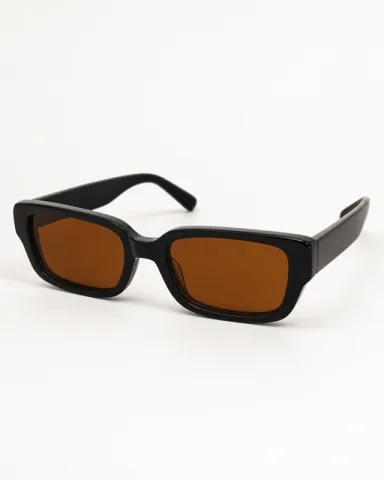 Clean ecommerce product image of the black sunglasses on an off-white background